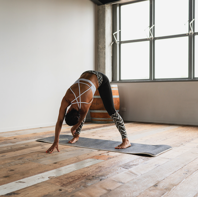 Woman doing yoga pose in yoga studio Woman doing yoga pose in yoga studio